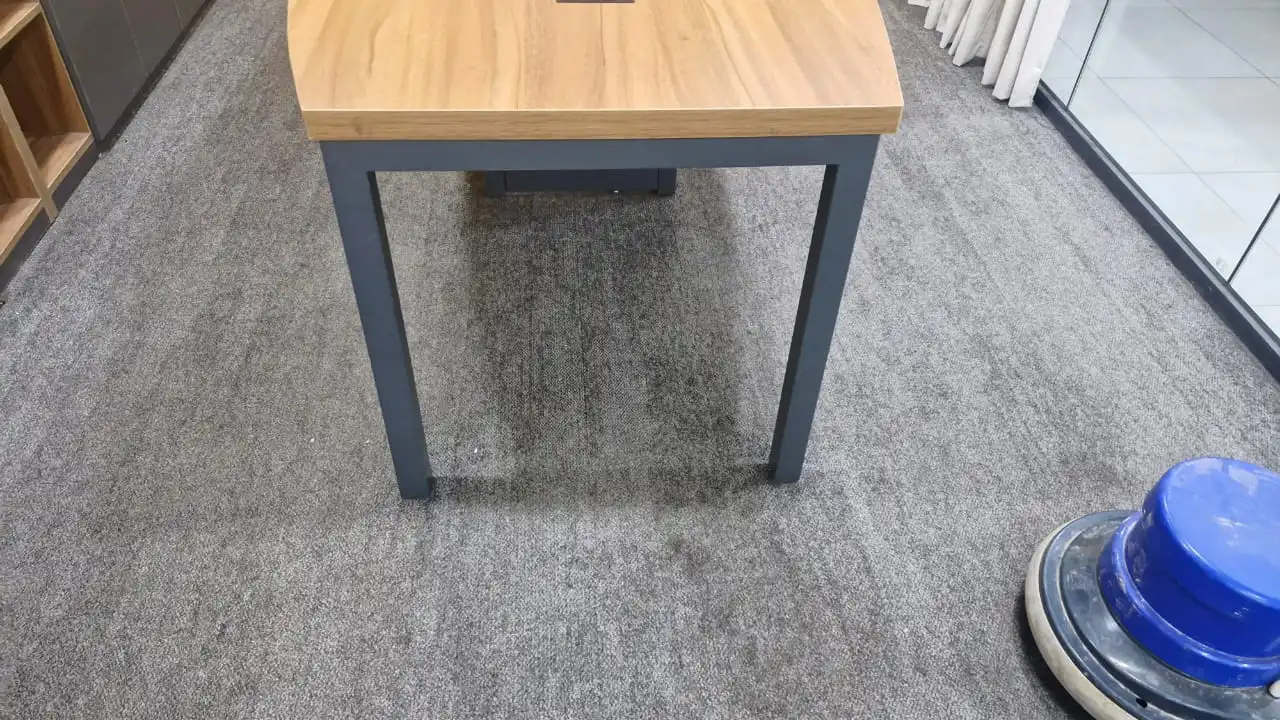 Rotary extraction machine treating an office carpet stain