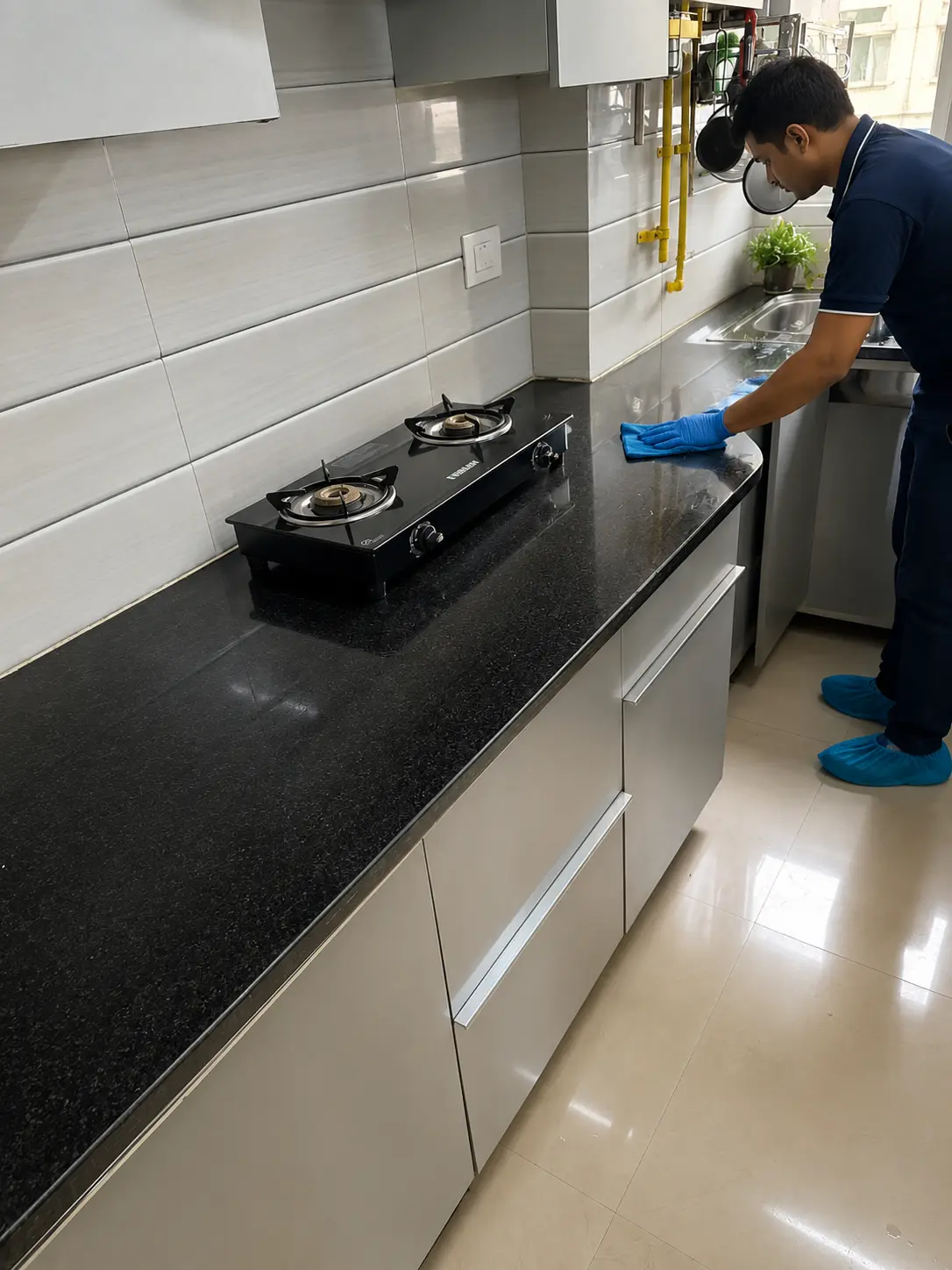 DryClean Masters technician degreasing a stove and countertop